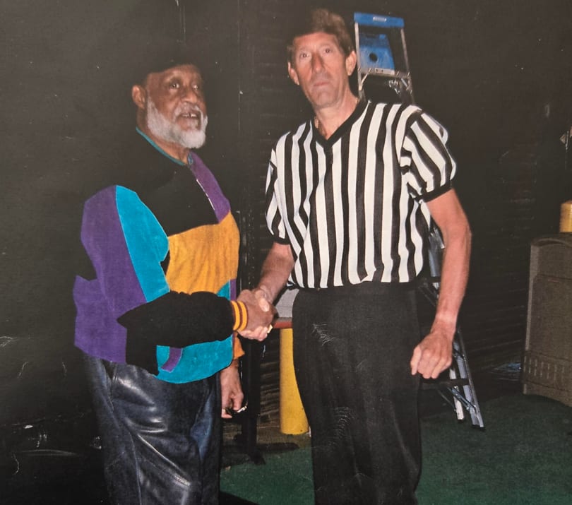 Jimmy shaking hands with a wrestler ringside